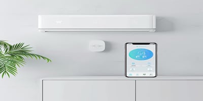Smart air conditioner with mobile app interface showing energy-saving settings.