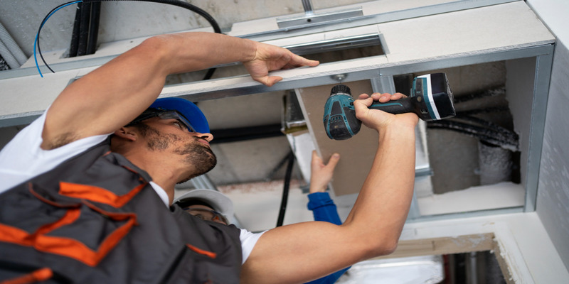 A man replaces equipment with modern heating, ventilation, and air conditioning control systems to reduce operating costs for commercial buildings.
