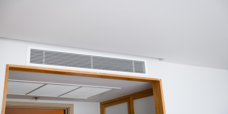 Ventilation grille above the doorway in a schoolroom.
