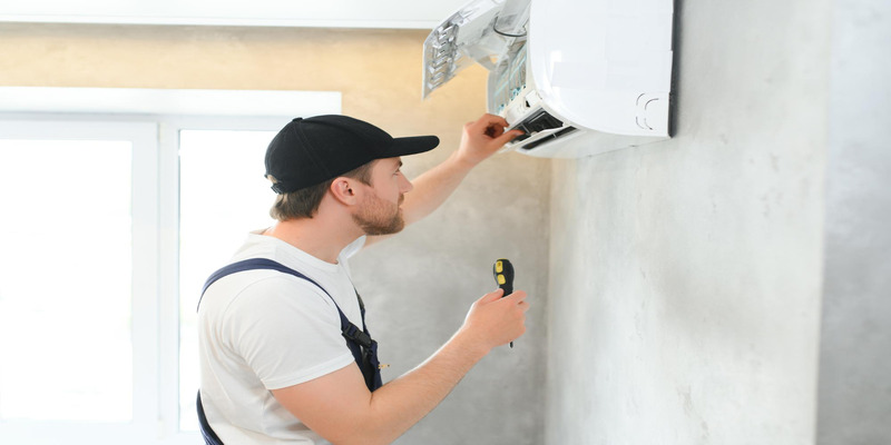 HVAC technician installing or servicing an indoor mini split air conditioner unit
