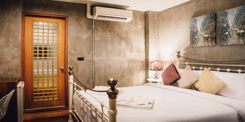 Hotel room with wall-mounted air conditioner above the bed