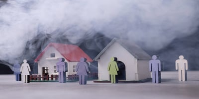 Miniature houses surrounded by smoke, symbolizing air pollution