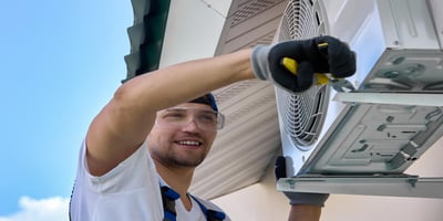 Technician repairing the AC to ensure cooling home during summer heat.