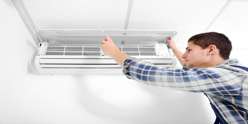 Technician cleaning air conditioner to reduce allergens