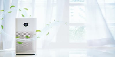 Air purifier by a bright window with a clean airflow leaf effect