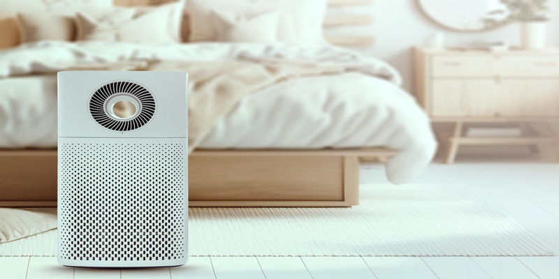 Air purifier in a minimalist bedroom with warm wooden decor