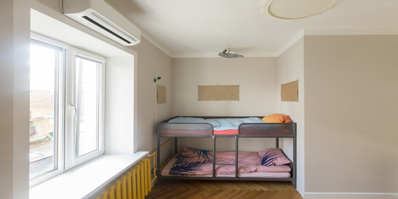 Dorm room with a bunk bed and air conditioner for dorm room.