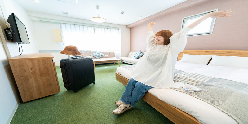 Hotel room with AC and suitcase