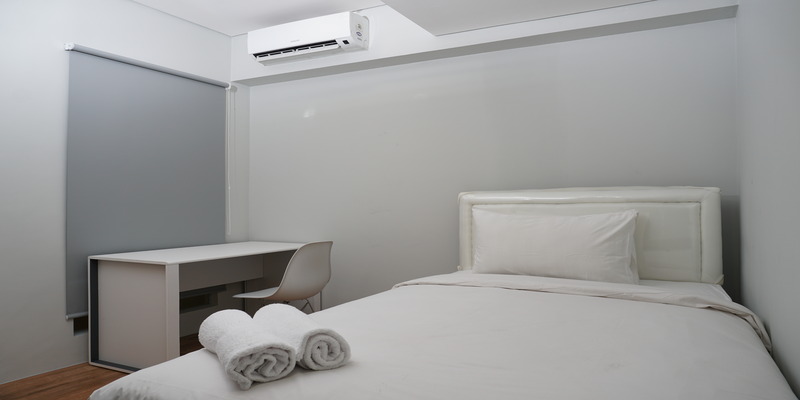 Bedroom with air conditioner for dorm room to stay cool.