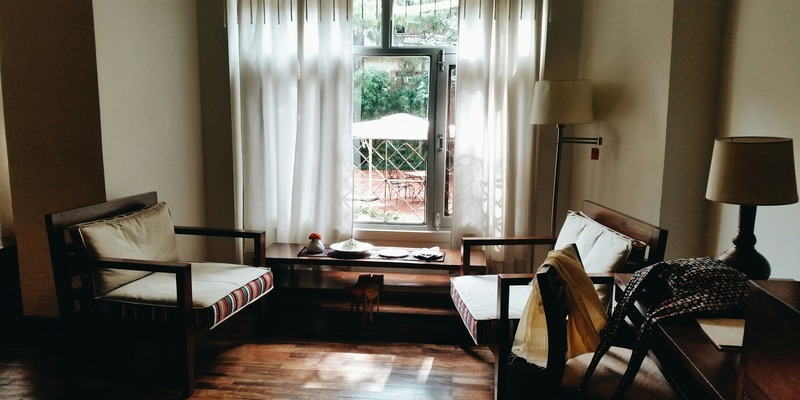 Cozy corner with seating and a bright window letting in natural light.