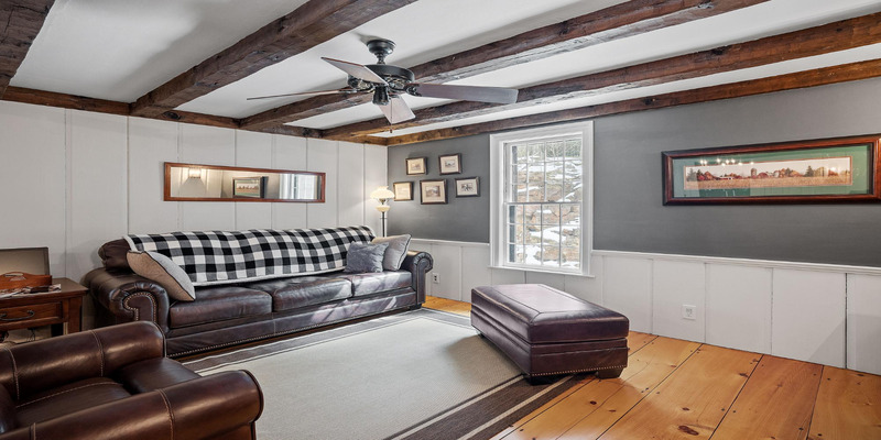 Living room with leather sofa and ac.