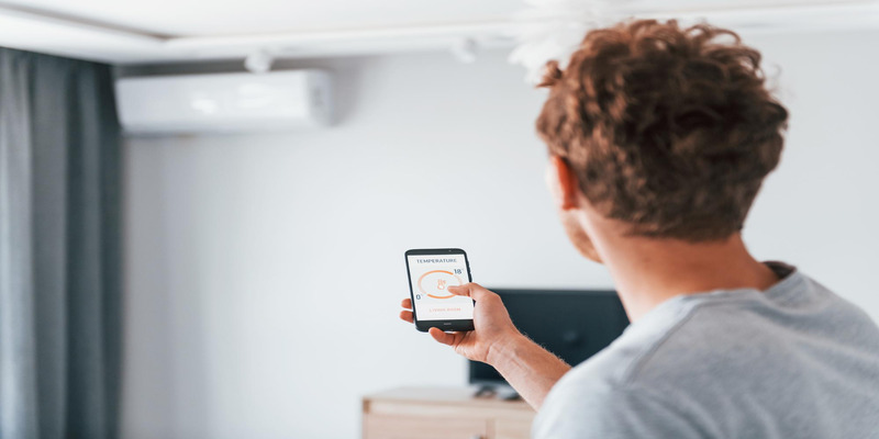 Man controls air conditioner via smartphone.