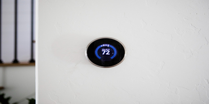 Smart thermostat on wall for thermostat energy savings winter